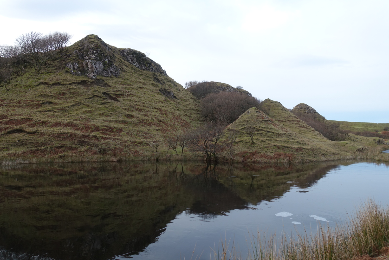 strangely shaped hills, a winding path, clusters of trees