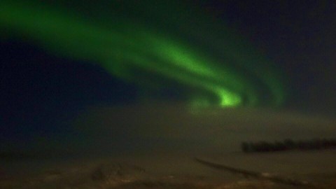 northern lights over a frozen lake. photo by lochie