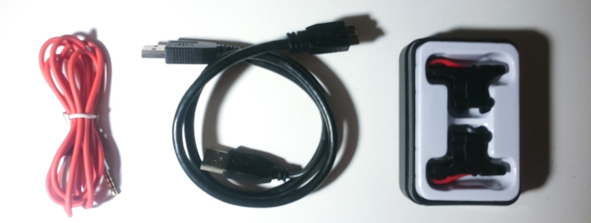 A cable, another cable, and a box containing two plastic widgets